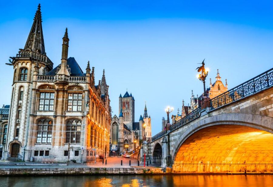 Dusk over Bruges, Belgium, highlighting the city's charming buildings and tranquil waterways in soft evening light.
