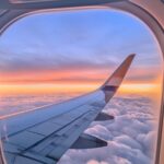 Window of an Airplane at Sunset