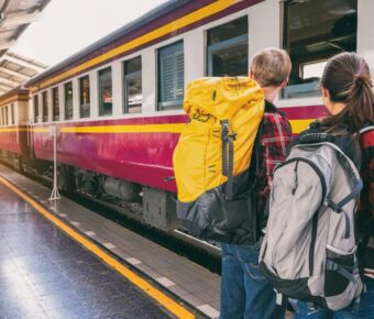 Couple backpacker waiting for train ride