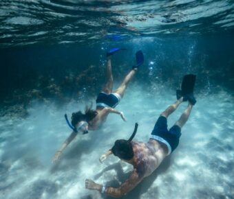 Couple free diving underwater