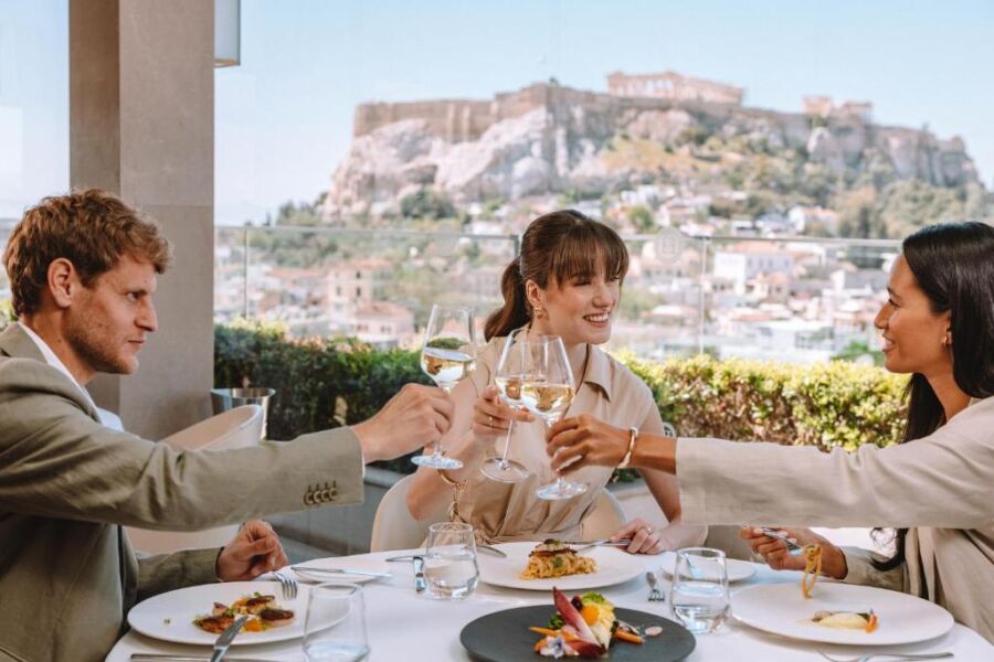 Hotel guests raising glasses for a toast at Electra Metropolis