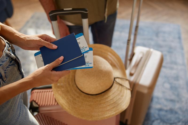 Female holding passport and boarding pass
