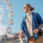 Handsome young man in casual clothing holding map