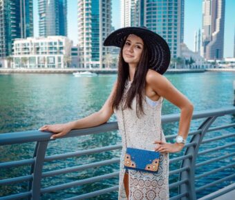 Happy young traveler woman in big city Dubai