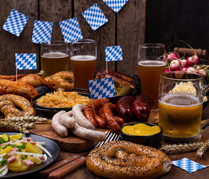 Oktoberfest beers and sausages in a wooden table