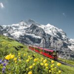 Swiss Alps with red train on a winter