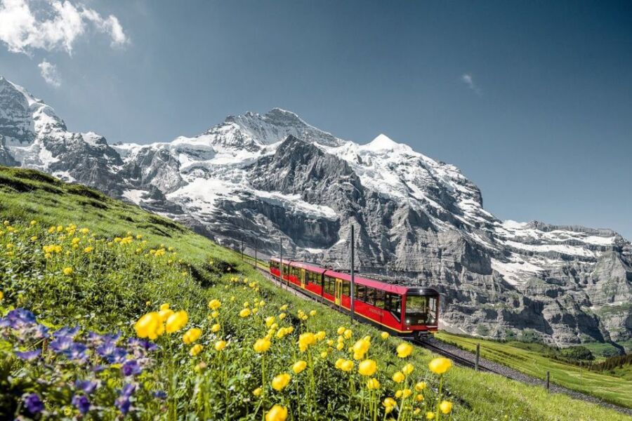 Swiss Alps with red train on a winter