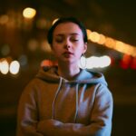 Woman in hoodie eyes closed