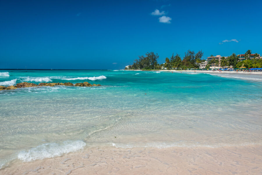 Accra Beach in Barbados, showcasing golden sands and turquoise waters under a clear blue sky