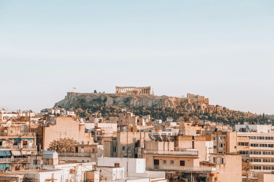Athens cityscape with Acropolis Parthenon, blending ancient history and modern urban life.