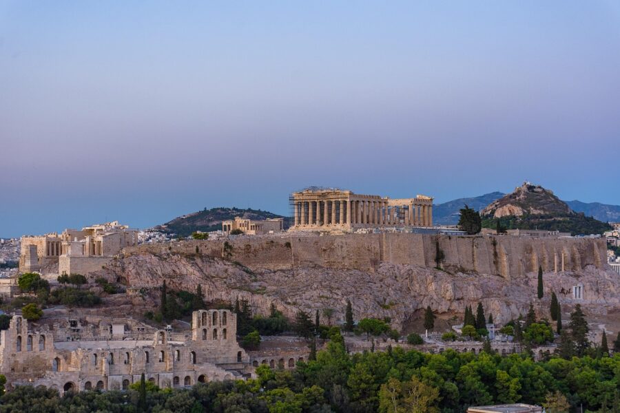 Twilight view of Athens Acropolis and Parthenon, showcasing ancient Greek architecture.