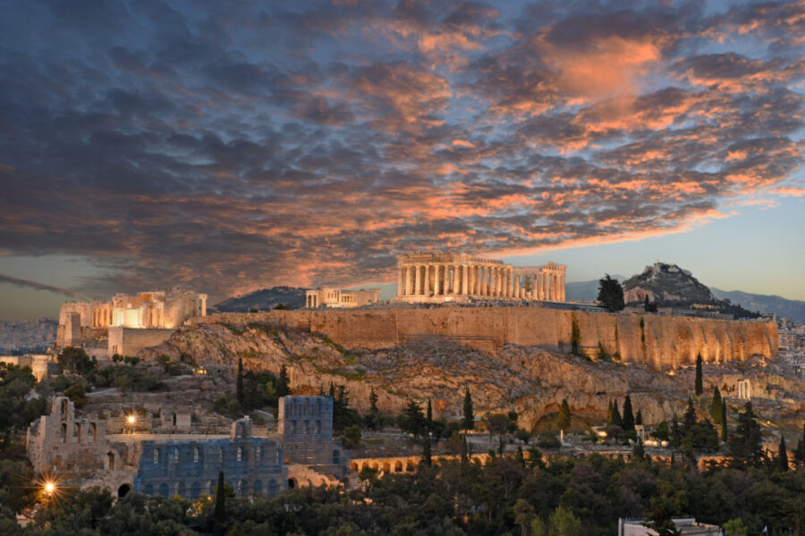 Night panorama of the Acropolis in Athens, showcasing ancient Greek ruins illuminated at dusk. A key landmark of the city