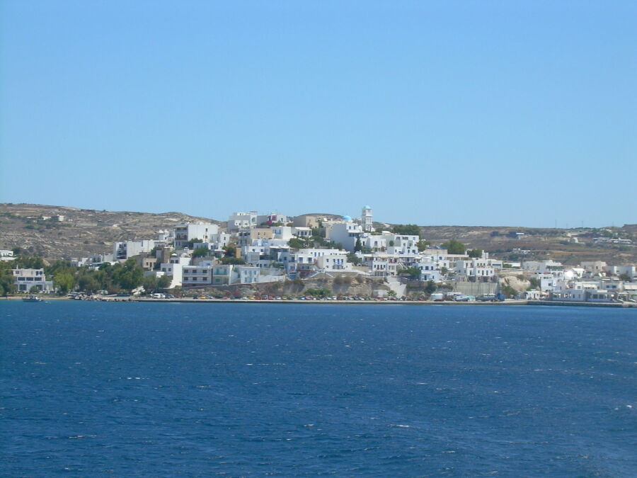 Expansive view of a large body of water in Adamas, Milos, Greece, with gentle waves and distant hills.