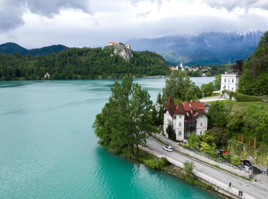 Scenic view of Lake Bled in Slovenia, featuring the Adora Luxury Hotel along the lakeside.