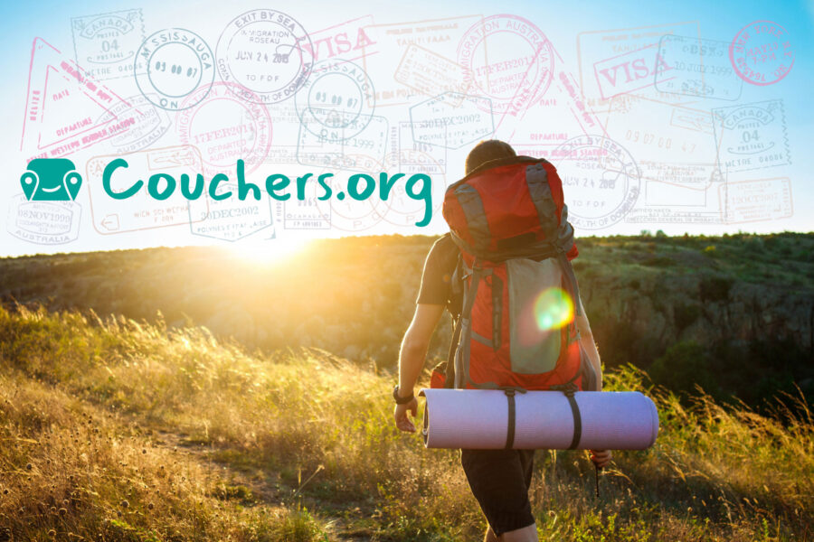 Adventurous traveler with backpack exploring sunlit landscapes, embracing world journeys with Couchers.org.