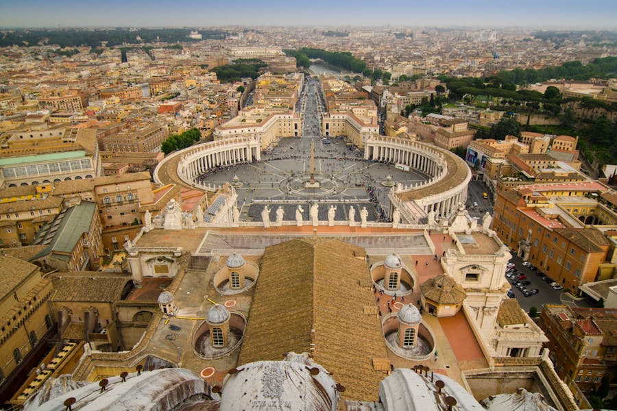 Aerial view of St. Peters Square with central obelisk and sweeping colonnades, Vatican Rome.