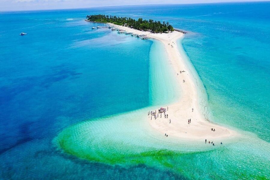 Aerial view of Malapascua sandbar and palm islet in turquoise waters.