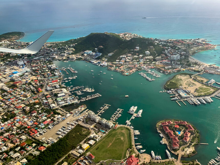 Aerial view of Sint Maarten showcasing vibrant beaches and lush landscapes under a clear blue sky
