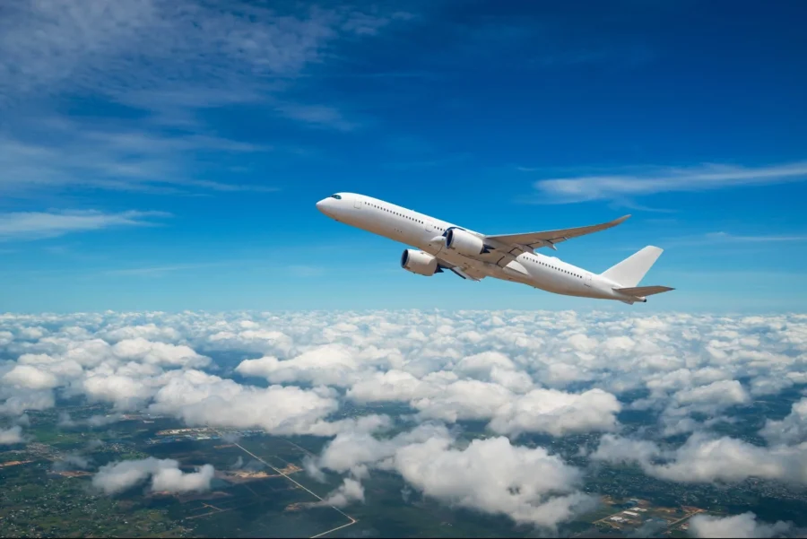Airplane ascending through blue sky, representing travel, adventure, and modern aviation technology.
