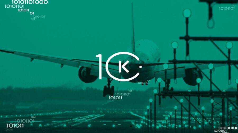 Airplane landing on tech-inspired runway with digital accents and 10K logo.