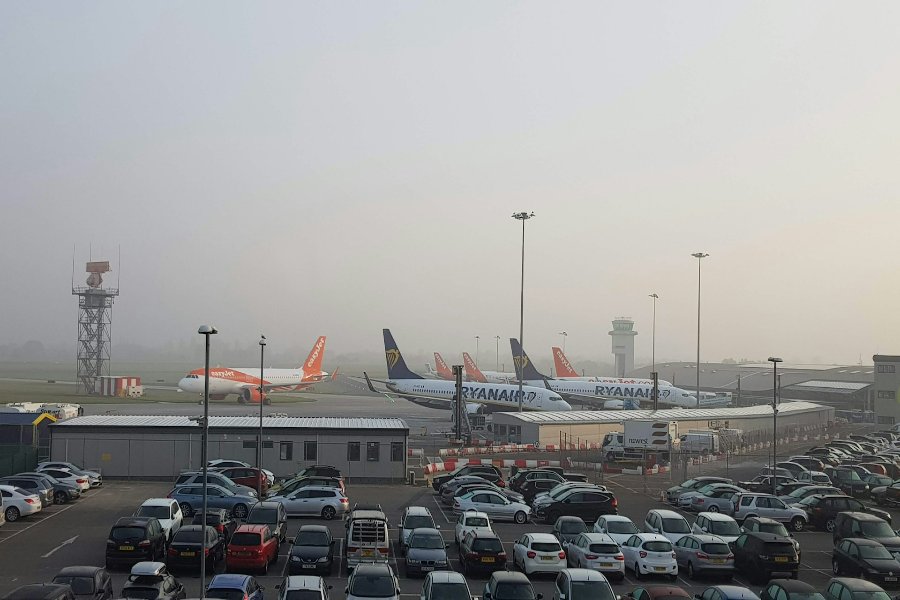 Airport parking lot and apron with Ryanair and easyJet planes lined up.