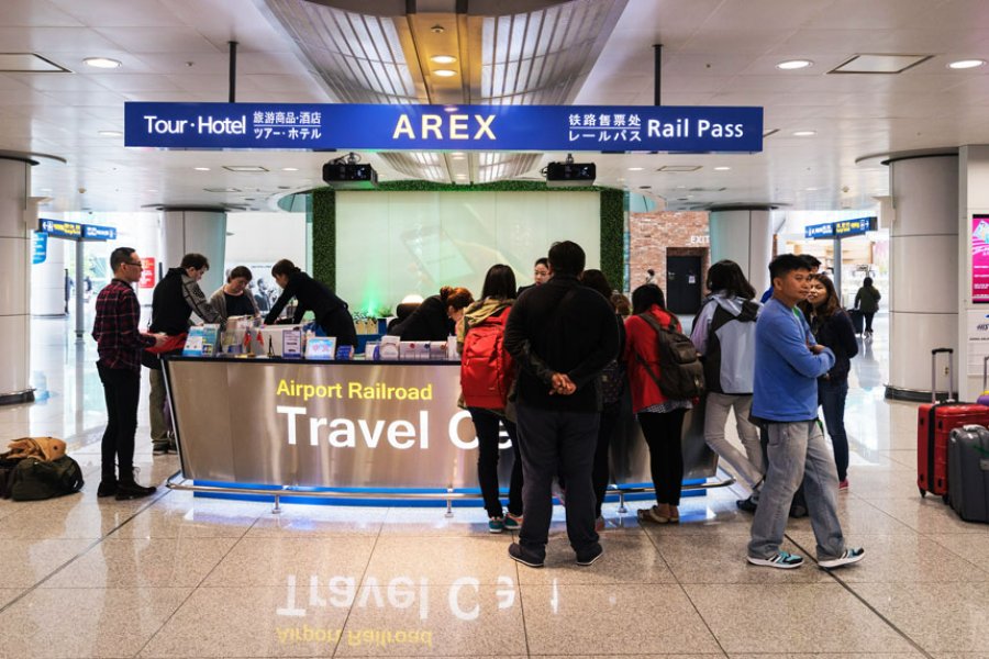 Airport AREX rail kiosk with travelers buying tickets and rail passes.