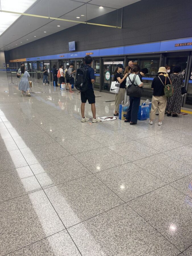 Passengers gathered at Incheon International Airport, waiting for the Airport Railroad Express train to arrive.