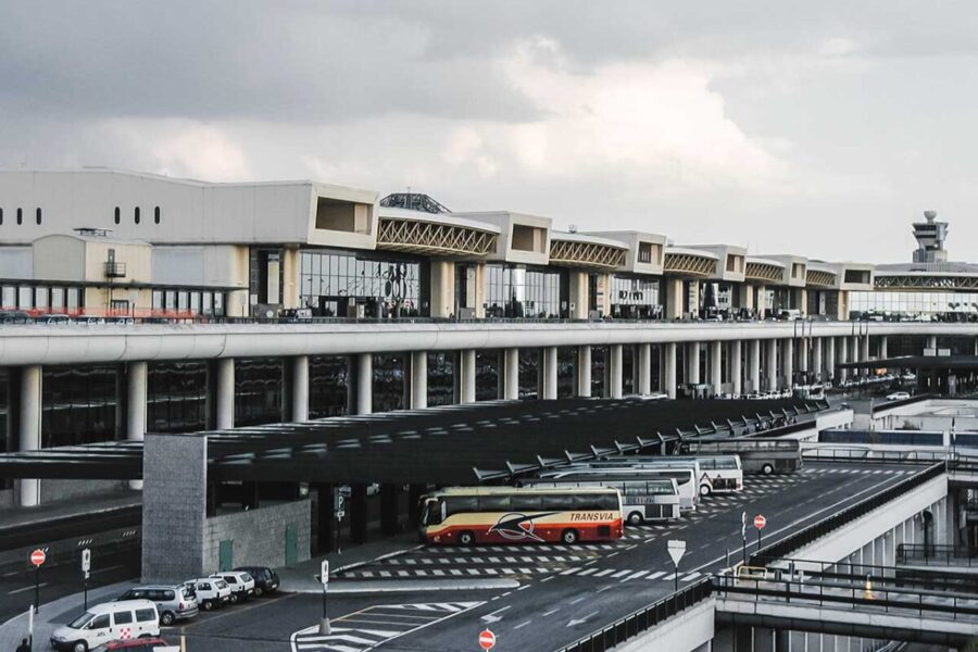 Milan Malpensa airport terminal coach drop-off and bus lanes.