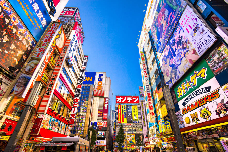 Vibrant Akihabara district in Tokyo, bustling with shops selling electronics, anime, games, and otaku merchandise.