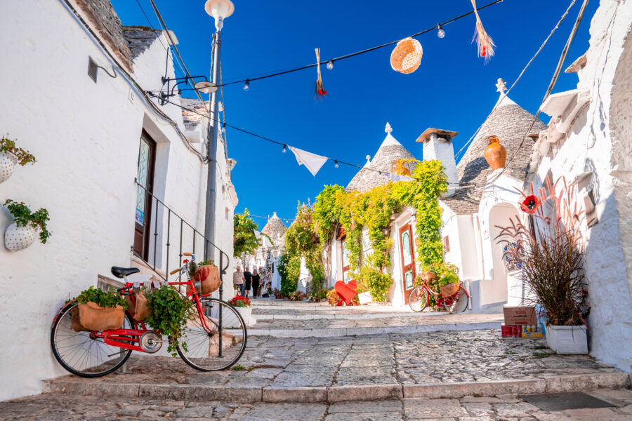 Traditional trulli houses in Alberobello, Puglia, showcasing unique conical roofs and charming stone architecture.