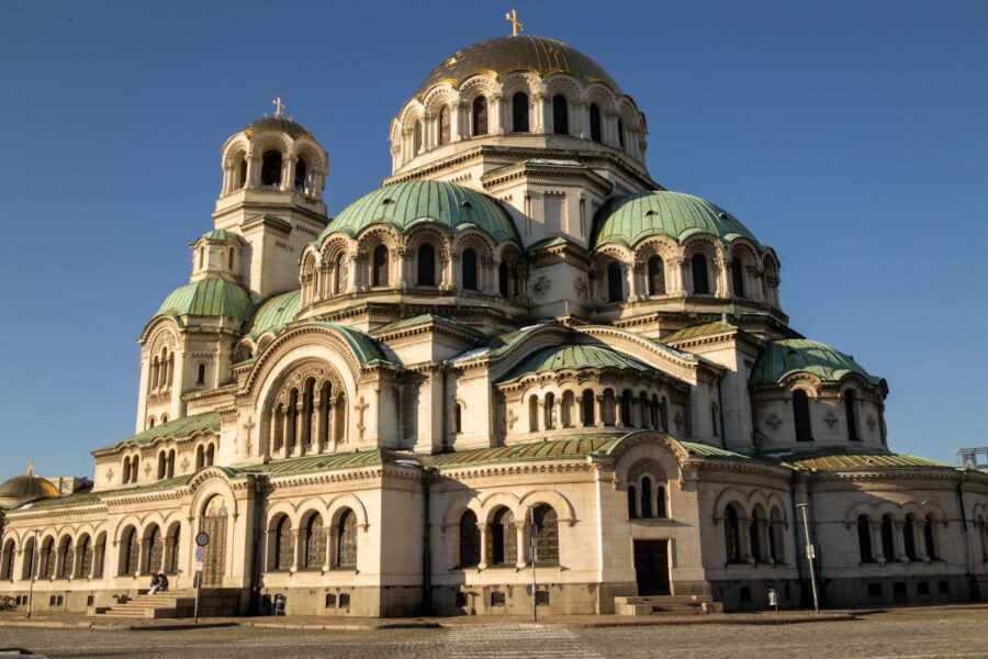 Grand Alexander Nevsky Cathedral with teal domes and golden crown in sunlight, Sofia.