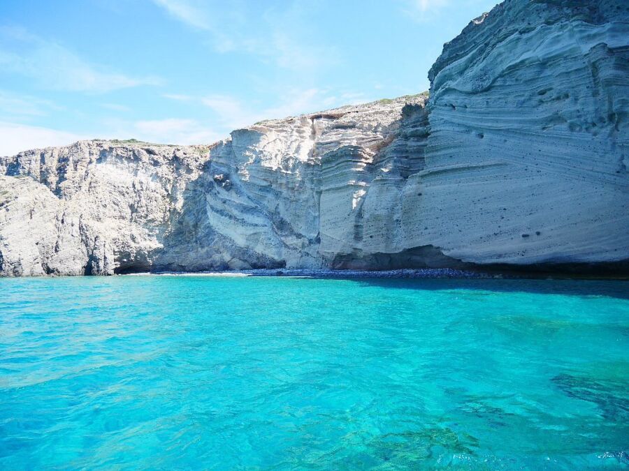 Serene blue waters and rugged cliffs along the coast of Aliki, Greece, showcasing the beauty of the Mediterranean landscape.