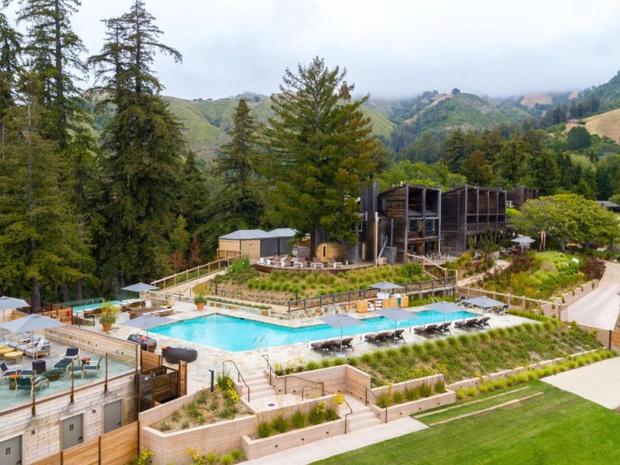 The pool at Alila Ventana Big Sur, a luxurious inclusive resort in Napa, surrounded by lush greenery and scenic views.
