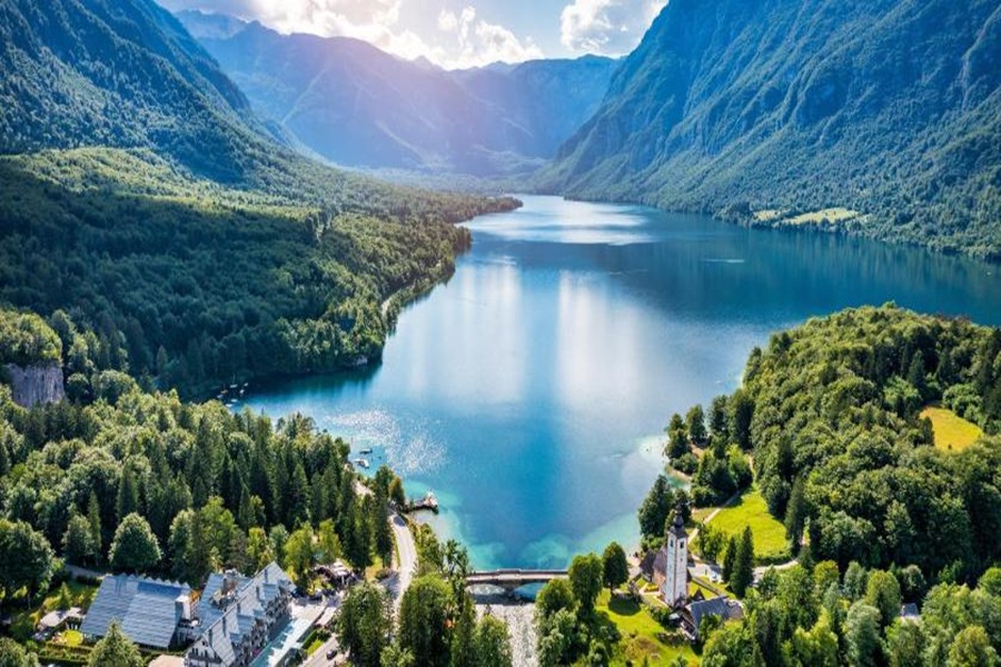 Lake Bohinj alpine lake village with church and turquoise water.