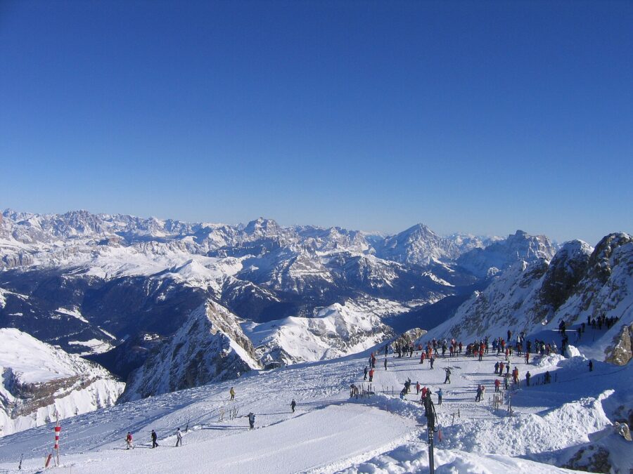 Scenic Alta Badia mountain range in the Dolomites, featuring towering peaks and a clear blue sky.
