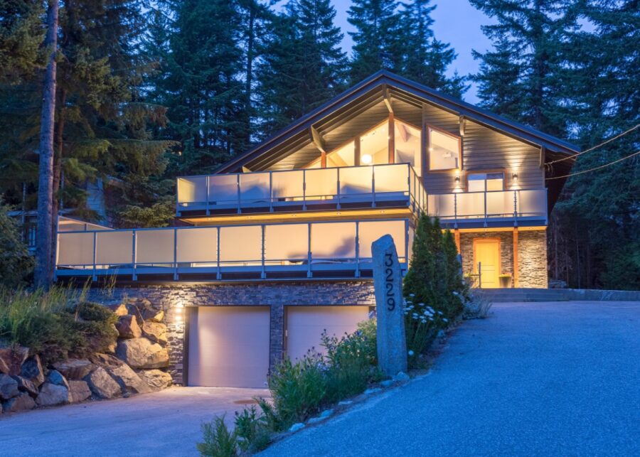 The driveway of the Alta Lake Chalet in Whistler, British Columbia, framed by lush greenery and scenic views.
