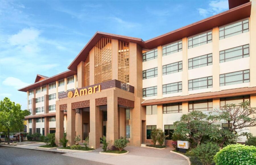 Modern Amari hotel exterior front view with tropical architecture, landscaped entrance and clear blue sky.