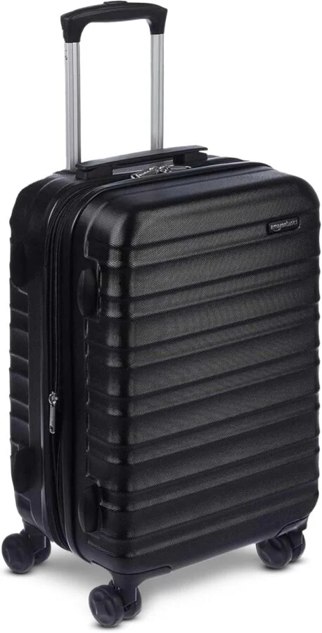Amazon Basics 21-inch black hardside carry-on spinner suitcase, expandable.