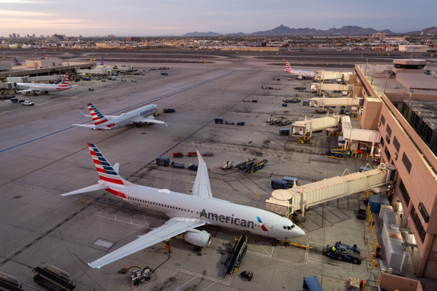 Sunset view American Airlines planes, showcasing vibrant colors against the terminal's architecture