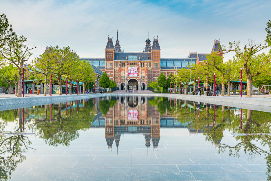 The Rijksmuseum in Amsterdam, Netherlands, showcasing its iconic architecture and attracting numerous tourists.