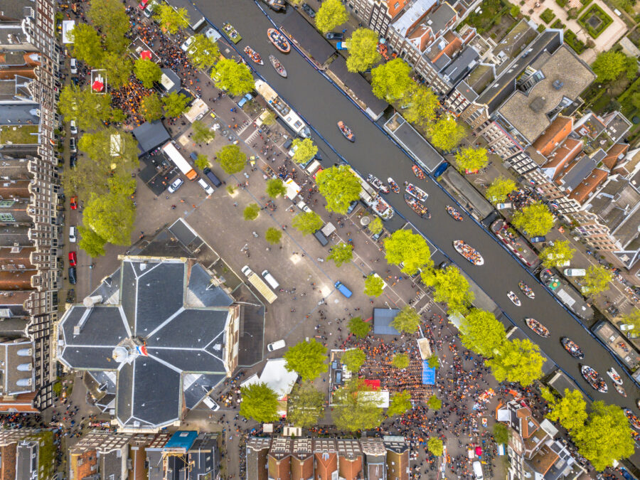 Aerial view of Amsterdam's Noordermarkt, showcasing vibrant market stalls and surrounding historic buildings.