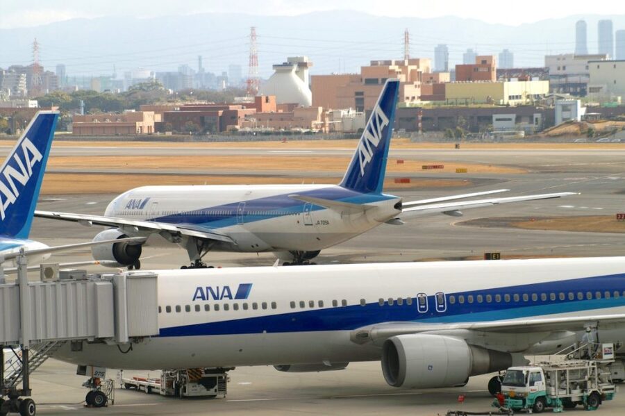 ANA aircraft at a bustling airport, highlighting urban proximity and modern aviation dynamics.