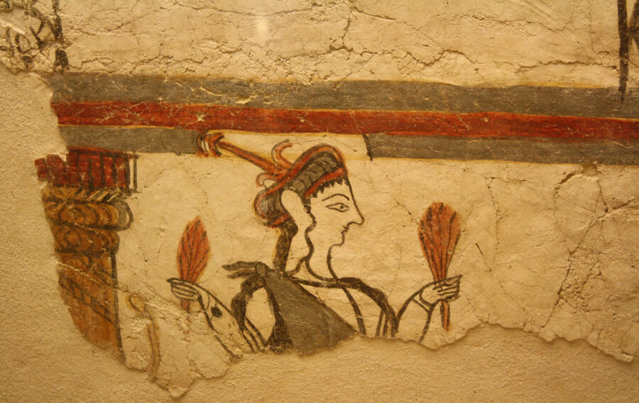 Ancient mural fragment depicting a female deity with fans and elaborate attire.