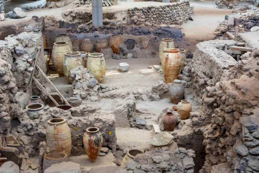 Archaeological dig of Akrotiri, featuring ancient structures and various ceramic artifacts.