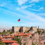 Ankara Castle stands against a bright blue sky in Ankara, Turkey, showcasing its historic architecture and scenic backdrop.