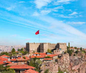 Ankara Castle stands against a bright blue sky in Ankara, Turkey, showcasing its historic architecture and scenic backdrop.