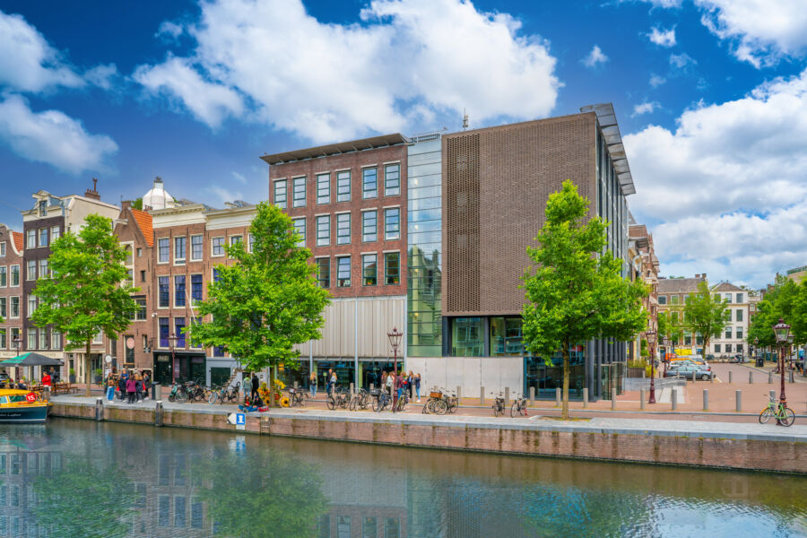 The exterior of the Anne Frank House in Amsterdam, showcasing its historic architecture and surrounding urban landscape