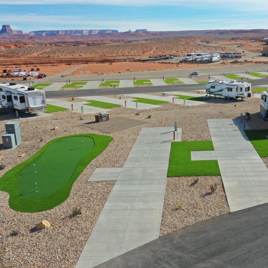 Scenic view of Antelope Point RV Park & Marina with lush grass and a golf course in the background.
