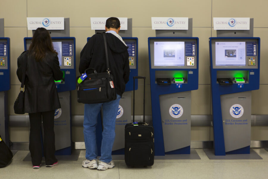 Automated kiosks for APC and Global Entry, designed for expedited customs processing at an airport.
