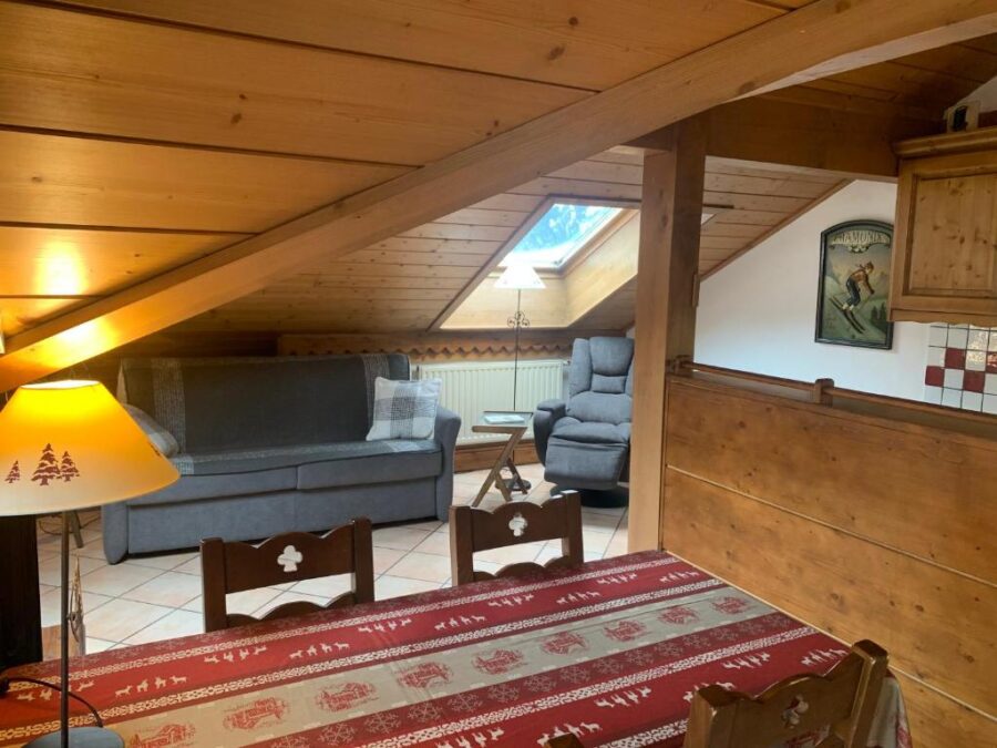 Interior of Appartement Les Arolles in Chamonix, France showcasing a small room with a table and chairs.